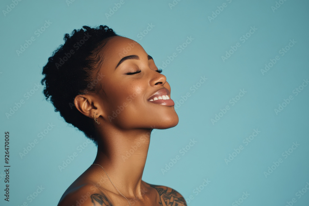 A close up of a tattooed black woman's face with her eyes closed A close up of a tattooed black woman's face with her eyes closed