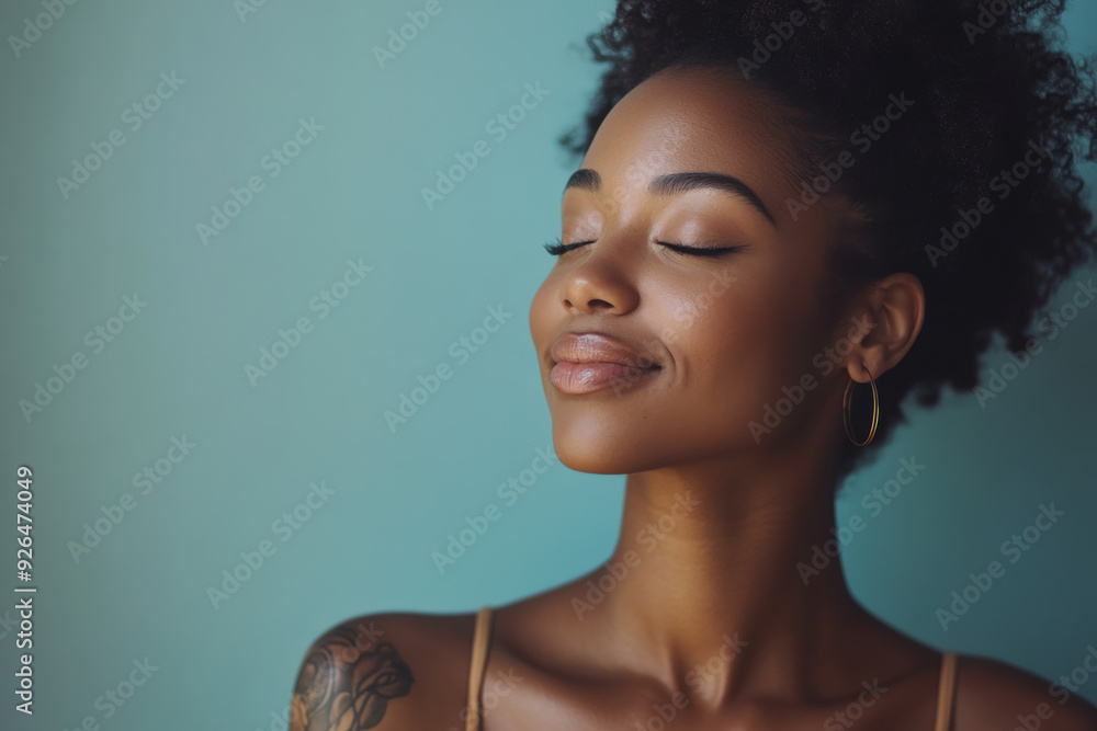 A close up of a tattooed black woman's face with her eyes closed A close up of a tattooed black woman's face with her eyes closed