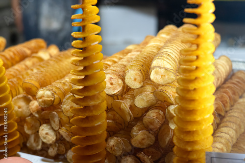 фотографія Tornado potato also called twist potato or potato twister on a stick at a street