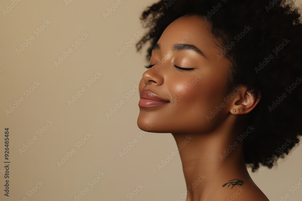 A close up of a tattooed black woman's face with her eyes closed A close up of a tattooed black woman's face with her eyes closed