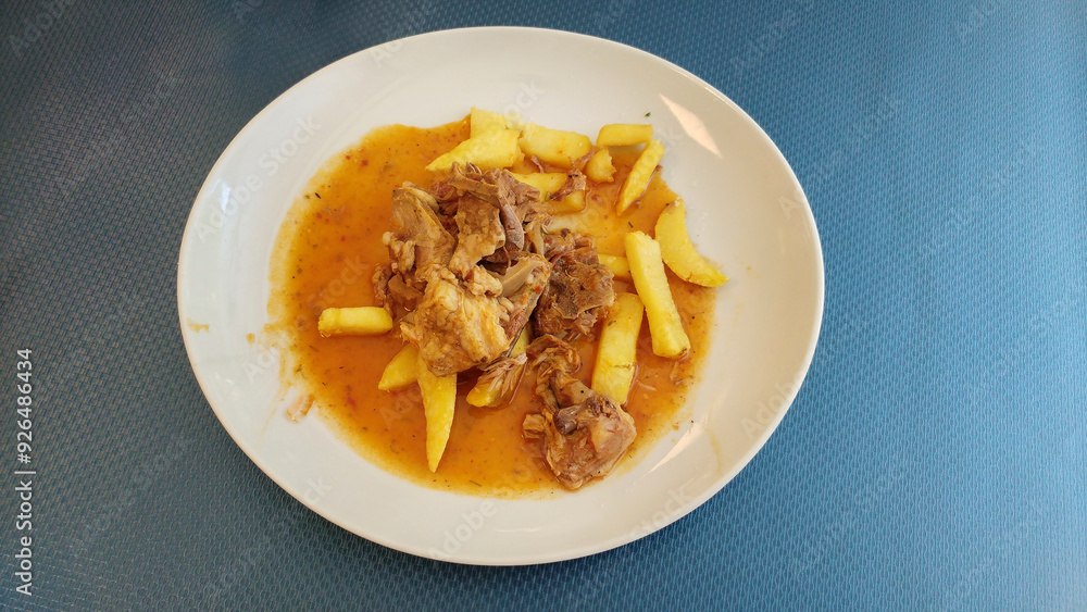 Lamb in chilindrón sauce with shredded potatoes and parsley Lamb in chilindrón sauce with shredded potatoes and parsley