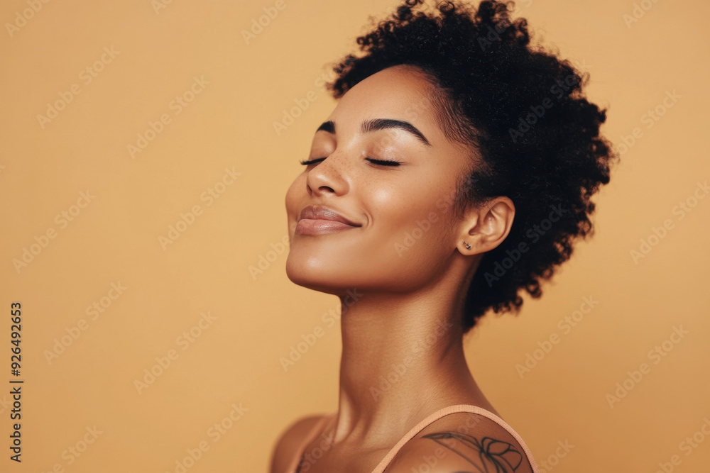 A close up of a tattooed black woman's face with her eyes closed A close up of a tattooed black woman's face with her eyes closed