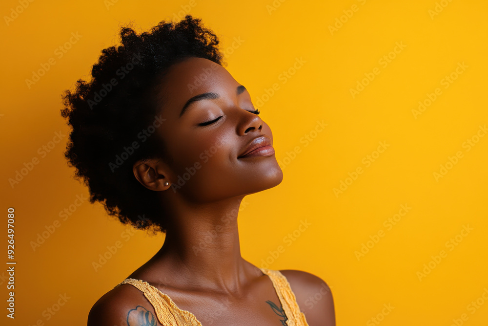 A close up of a tattooed black woman's face with her eyes closed A close up of a tattooed black woman's face with her eyes closed