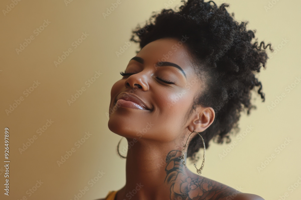 A close up of a tattooed black woman's face with her eyes closed A close up of a tattooed black woman's face with her eyes closed
