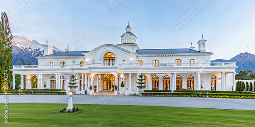 White luxury palatial estate home in the countryside. New Zealand landscape setting, fictitious property
