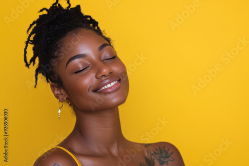 A close up of a tattooed black woman's face with her eyes closed