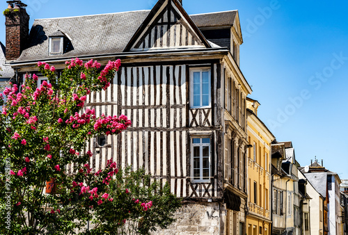 Fototapeta Naklejka Na Ścianę i Meble -  Iconic half-timbered house with pink flowers, in the city of Rouen, Normandy region, France. 