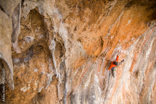 A rock climber ascends to the summit via a difficult route. photo