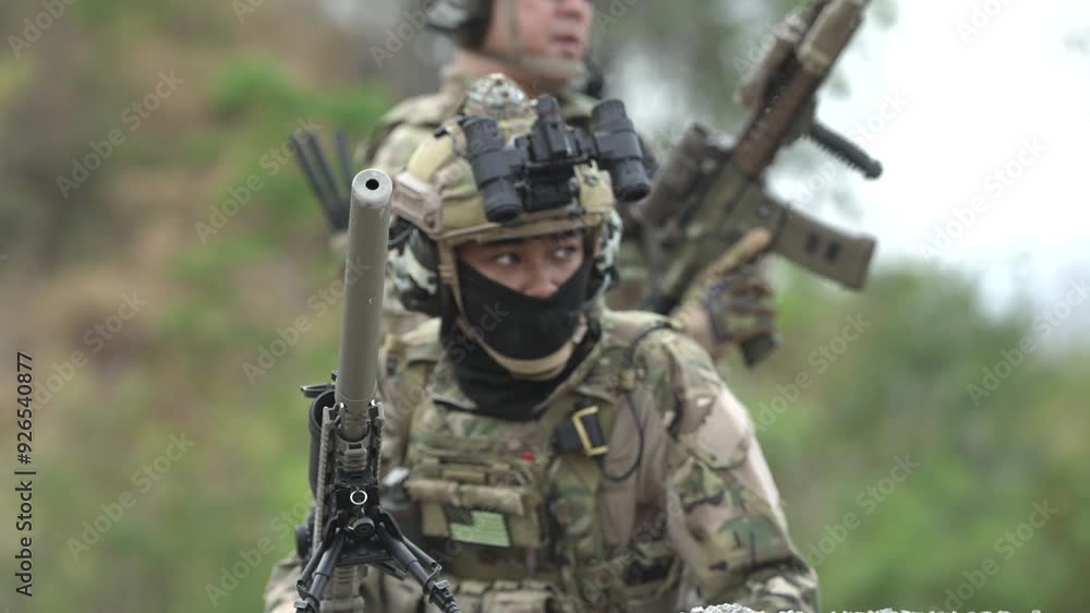A group of military men in combat gear patrol in the middle of a desert and tropical jungle. Soldiers in full combat gear in dry weather conditions assemble and march on a mission. A group of military men in combat gear patrol in the middle of a desert and tropical jungle. Soldiers in full combat gear in dry weather conditions assemble and march on a mission.