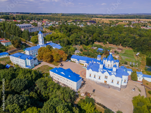 The colorful photo of Korennaya Pustyn in Kursk region, Russia, a beautiful Orthodox church with the green forest and panoramic landscape.
 photo