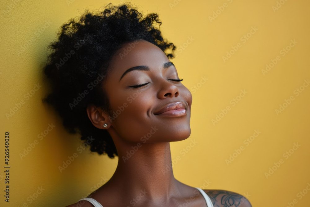 A close up of a tattooed black woman's face with her eyes closed A close up of a tattooed black woman's face with her eyes closed