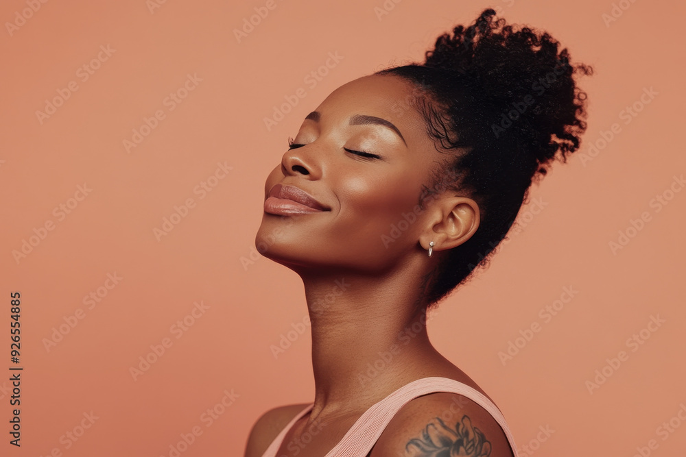 A close up of a tattooed black woman's face with her eyes closed A close up of a tattooed black woman's face with her eyes closed