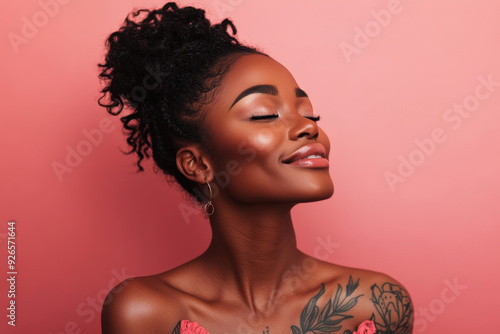 A close up of a tattooed black woman's face with her eyes closed