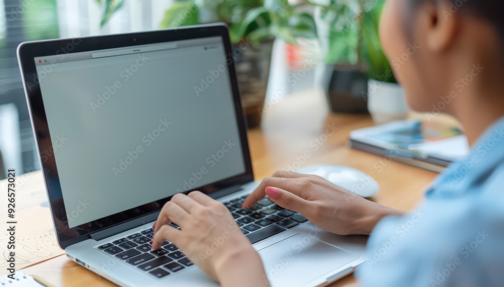 A close-up shot of a woman typing on a laptop in a home office setting, surrounded by green plants and natural light for a productive workspace.
A close-up shot of a woman typing on a laptop in a home office setting, surrounded by green plants and natural light for a productive workspace.