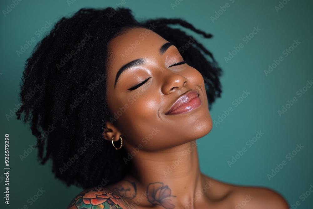 A close up of a tattooed black woman's face with her eyes closed A close up of a tattooed black woman's face with her eyes closed