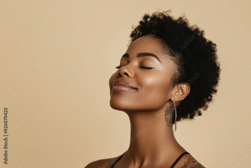 A close up of a tattooed black woman's face with her eyes closed A close up of a tattooed black woman's face with her eyes closed
