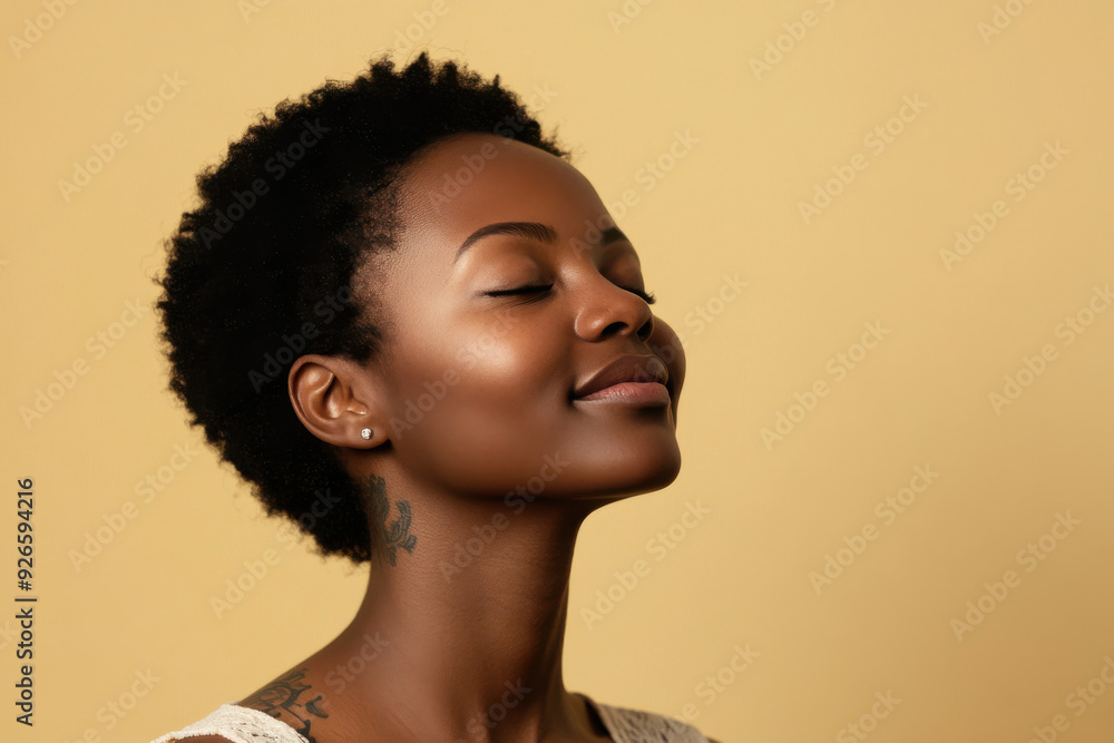 A close up of a tattooed black woman's face with her eyes closed A close up of a tattooed black woman's face with her eyes closed