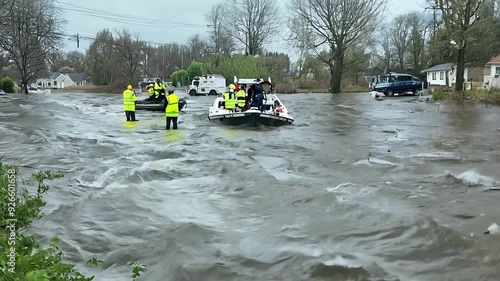 Rescue team navigating flooded street with inflatable boats
