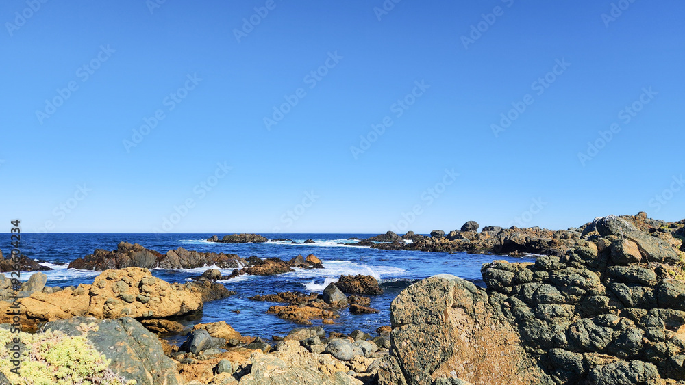 WAVES HITTING ON THE ROCKS. PACIFIC OCEAN COAST IN CHILE. WAVES HITTING ON THE ROCKS. PACIFIC OCEAN COAST IN CHILE.
