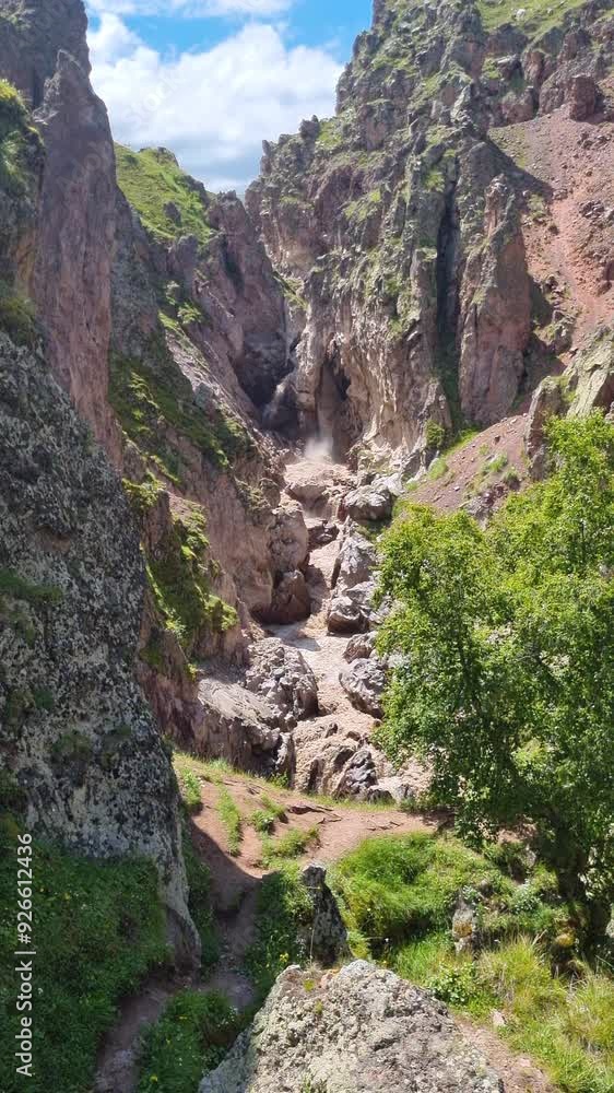 Mountain river flowing through a narrow rocky gorge. Vertical video. Mountain river flowing through a narrow rocky gorge. Vertical video.
