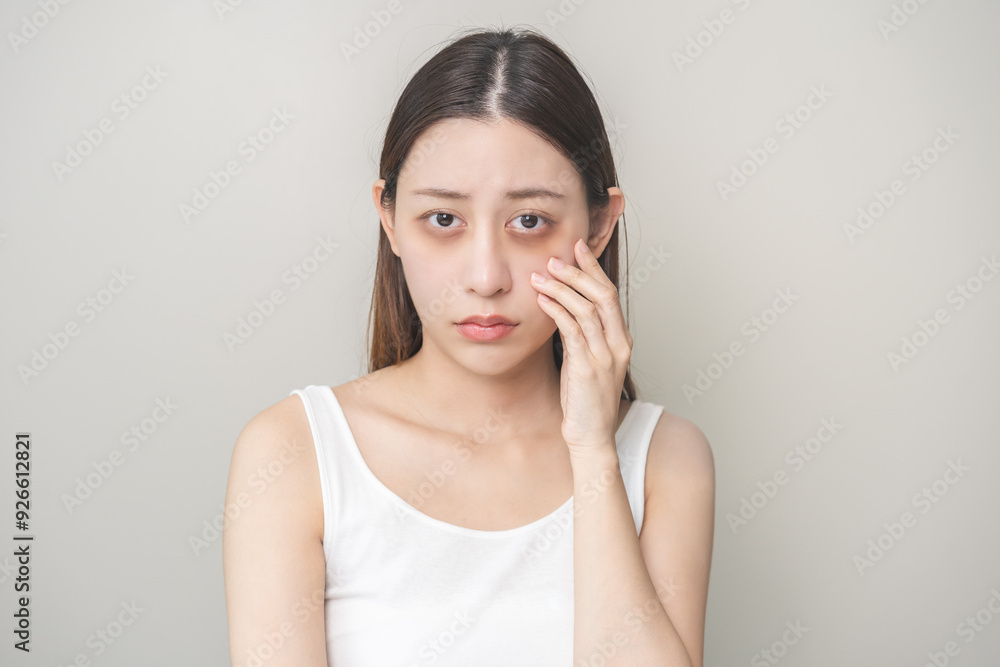 Bored, insomnia asian young woman, girl looking at camera, hand touching under eyes with problem of black circles or panda puffy, swollen and wrinkle on face. Sleepless, sleepy healthcare person. Bored, insomnia asian young woman, girl looking at camera, hand touching under eyes with problem of black circles or panda puffy, swollen and wrinkle on face. Sleepless, sleepy healthcare person.