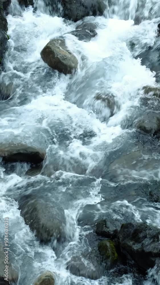 Slow motion of abundant stream of water flowing in a mountain river. Slow motion of abundant stream of water flowing in a mountain river.
