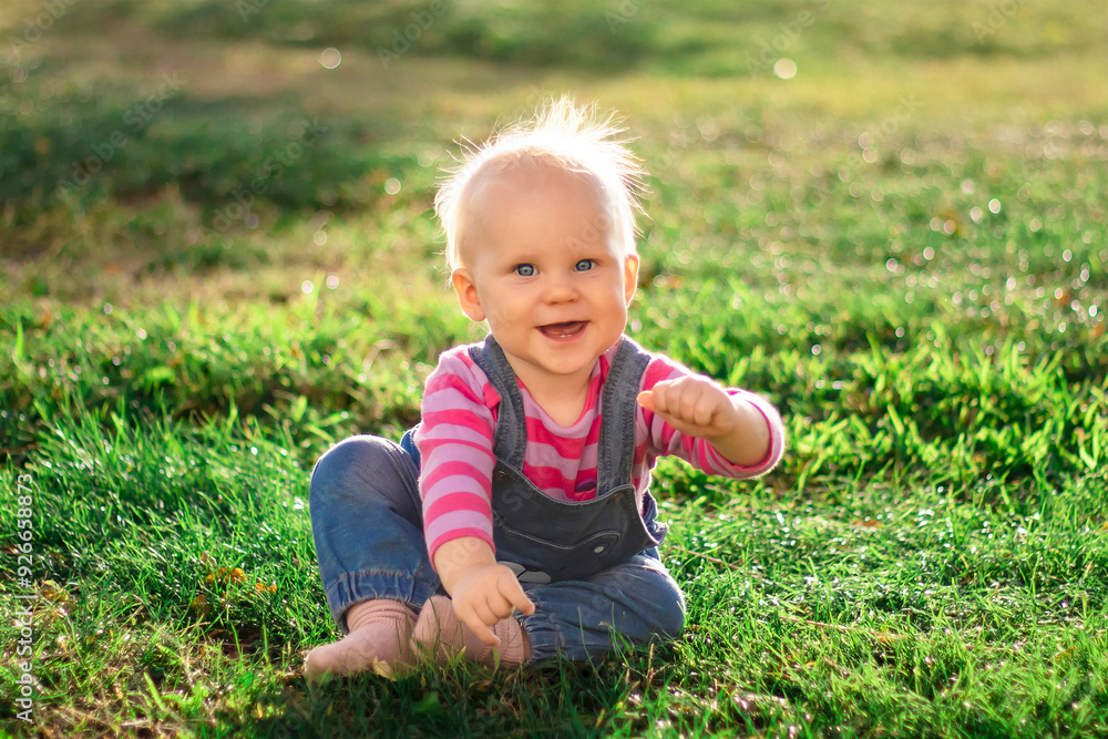 A Cute Baby Delightfully Having Fun While Enjoying Nature and Playing in the Warm Sunshine A Cute Baby Delightfully Having Fun While Enjoying Nature and Playing in the Warm Sunshine