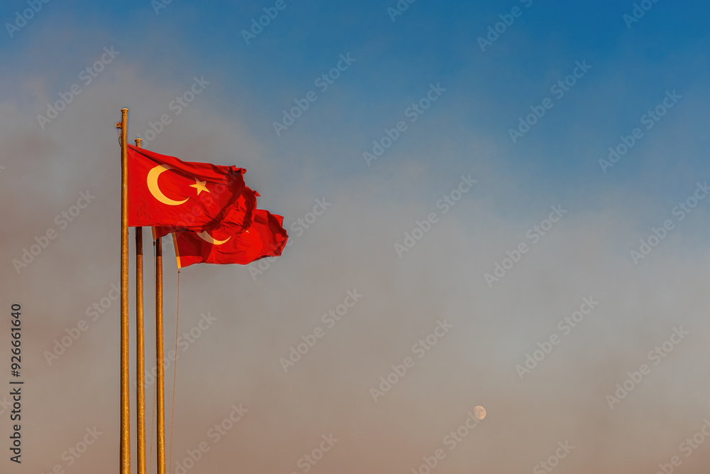 Turkish flag waving on the Izmir - Karşıyaka beach and the rising moon in the background.