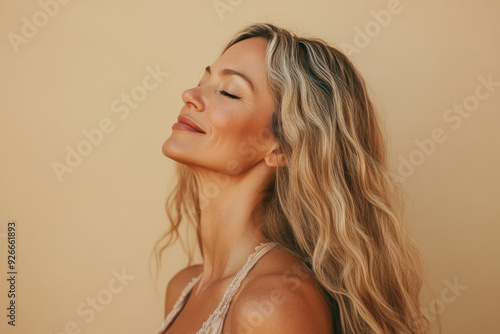 A close up of a black woman's face with her eyes closed and long blond hair