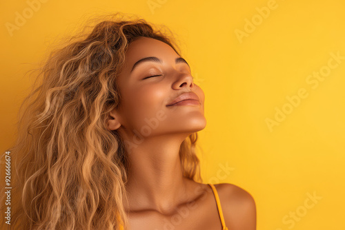 A close up of a black woman's face with her eyes closed and long blond hair