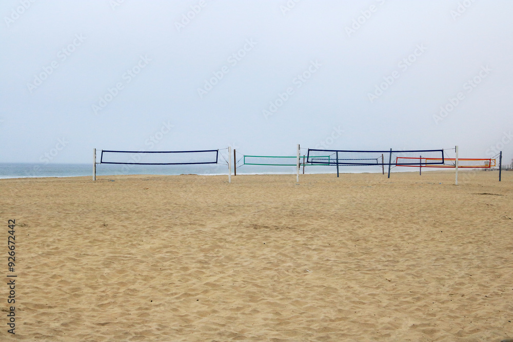 Colorful nets of volleyball courts at South Mission beach covered with morning ocean fog, San Diego, California Colorful nets of volleyball courts at South Mission beach covered with morning ocean fog, San Diego, California