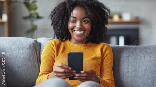 Woman with smartphone at home.