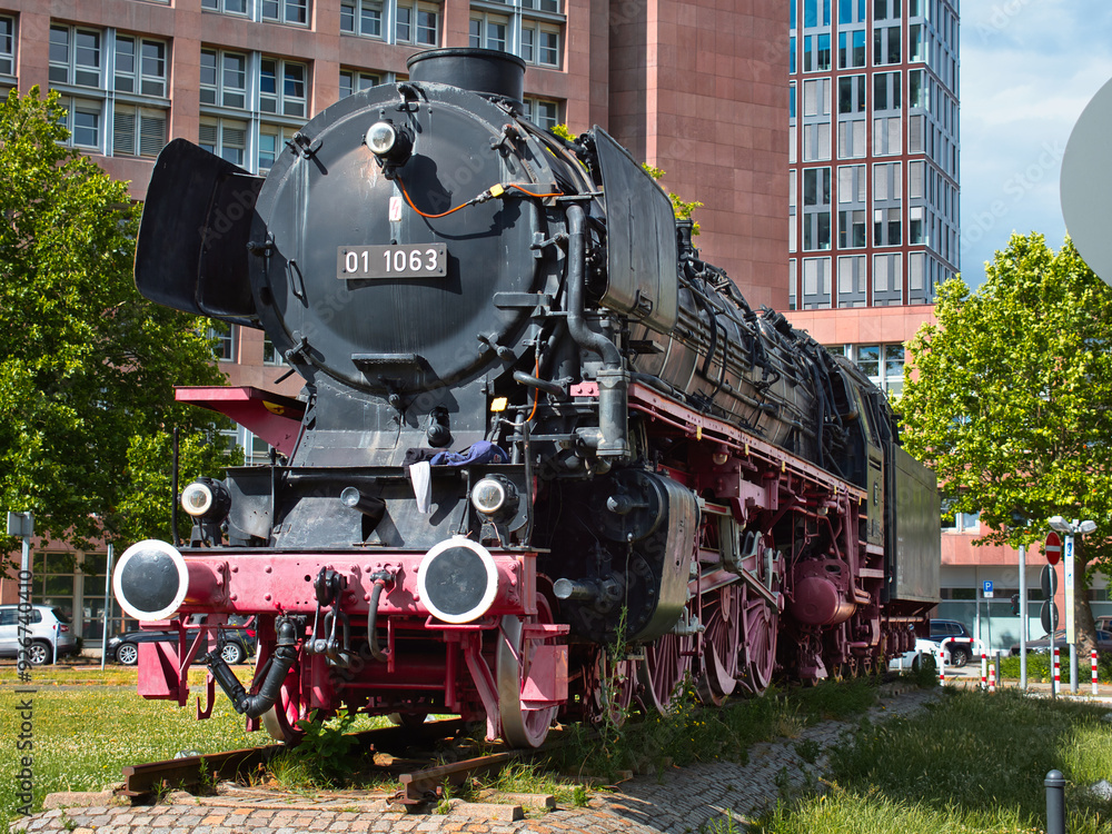 Obraz premium old steam locomotive, which is black and red and stands at the main station in Braunschweig as a museum piece