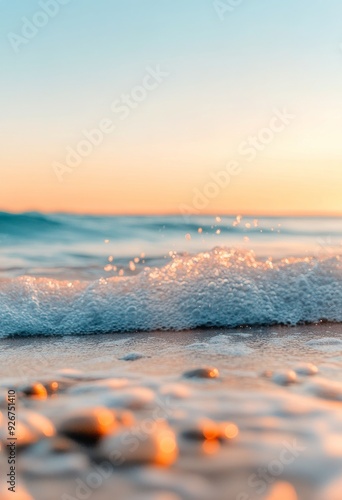 Gentle waves lap against the shore at sunset on a serene beach
