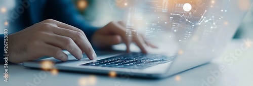 Person typing on a laptop while data visuals appear in a modern workspace
