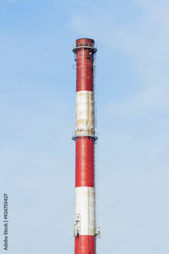 An industrial chimney against a clear sky, painted white and red | Komin przemysłowy na tle czystego nieba, pomalowany na biało-czerwono An industrial chimney against a clear sky, painted white and red | Komin przemysłowy na tle czystego nieba, pomalowany na biało-czerwono