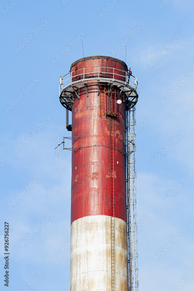An industrial chimney against a clear sky, painted white and red | Komin przemysłowy na tle czystego nieba, pomalowany na biało-czerwono An industrial chimney against a clear sky, painted white and red | Komin przemysłowy na tle czystego nieba, pomalowany na biało-czerwono