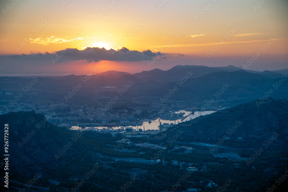 Fototapeta premium View from above of the coast of Cartagena, Region of Murcia, Spain, at dawn with the city's port as the protagonist