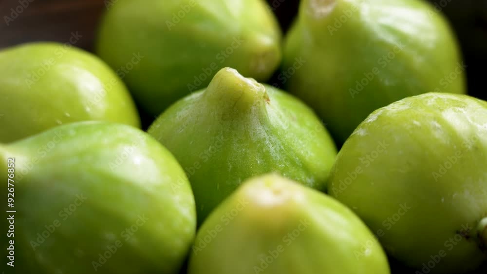 Nutrient-rich raw organic fig with high nutritional benefits in wooden bowl. Fresh green fruits. Close up. Rotation Nutrient-rich raw organic fig with high nutritional benefits in wooden bowl. Fresh green fruits. Close up. Rotation