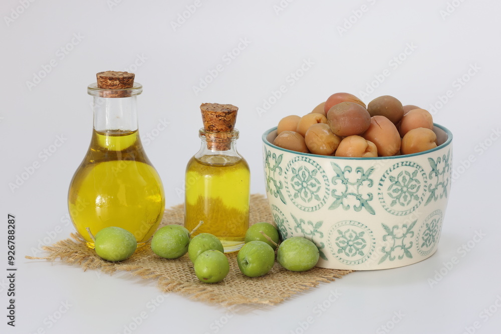 olive oil and pickled green olives on white background olive oil and pickled green olives on white background