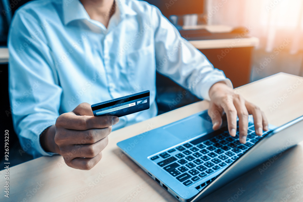 Young man use credit card for shopping payment online on laptop computer application or website. E-commerce and online shopping concept. uds Young man use credit card for shopping payment online on laptop computer application or website. E-commerce and online shopping concept. uds