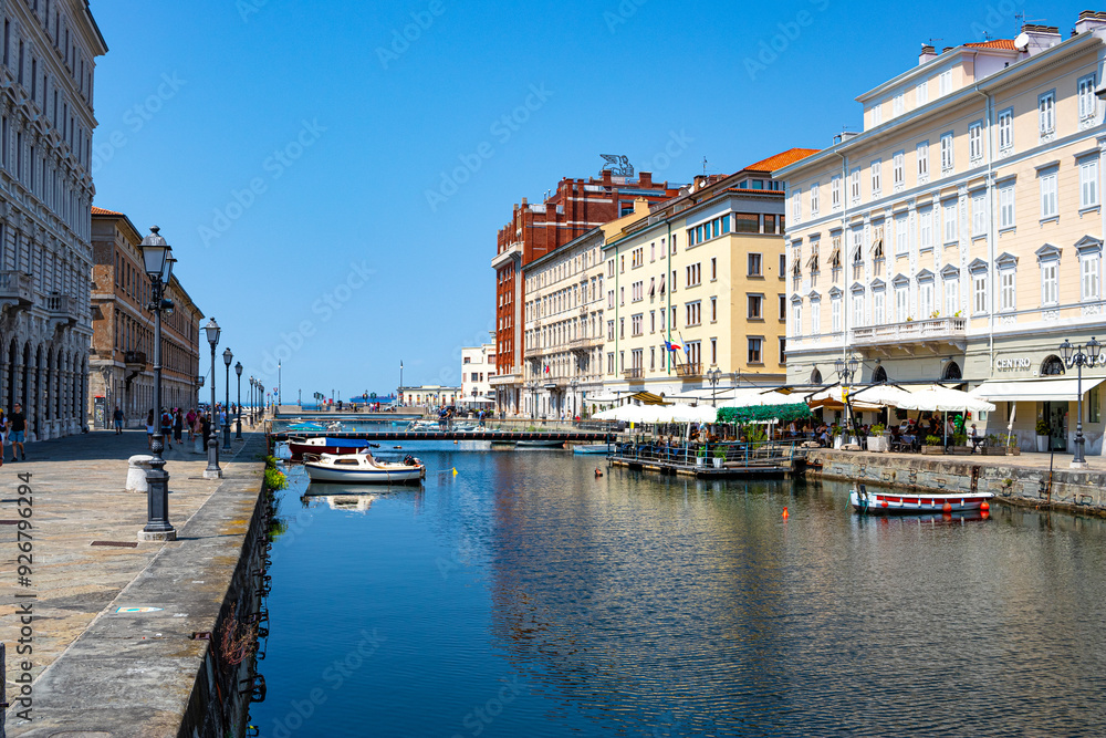 Naklejka premium Grand Canal in Trieste Italy with bridges, boats and houses flowing into the sea