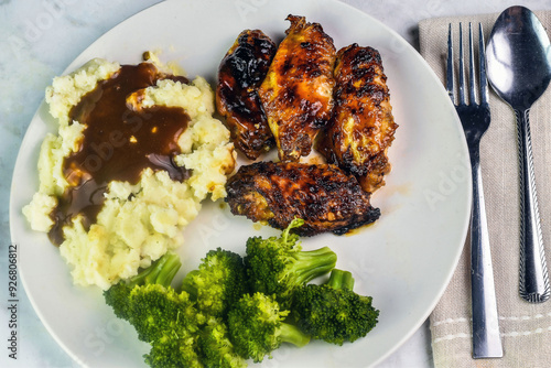 barbecue wings with  mash potatoes and gravy photo