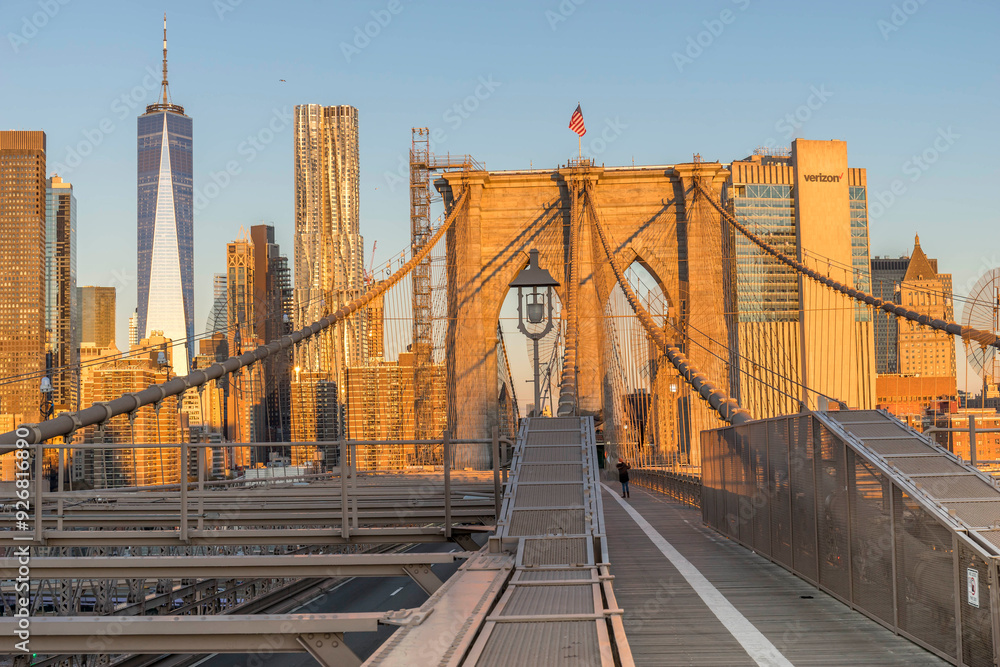 Fototapeta premium Brooklyn Bridge over East River viewed from New York City Lower Manhattan waterfront at sunrise
