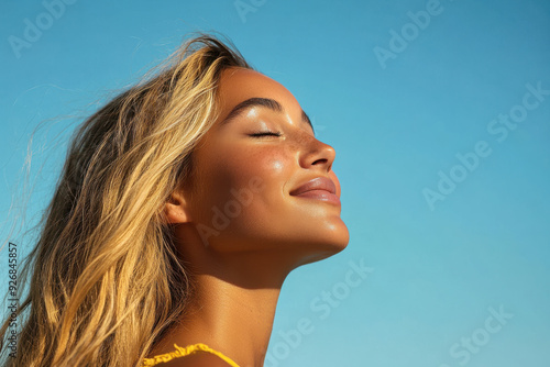 A close up of a woman's face with her eyes closed and long blond hair