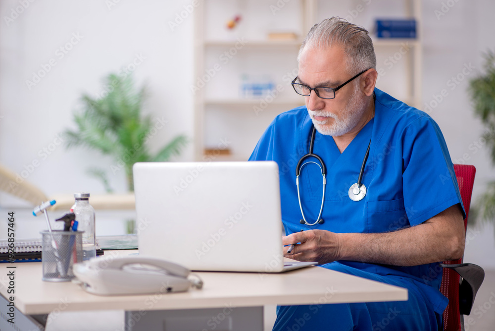 Old male doctor in telemedicine concept Old male doctor in telemedicine concept
