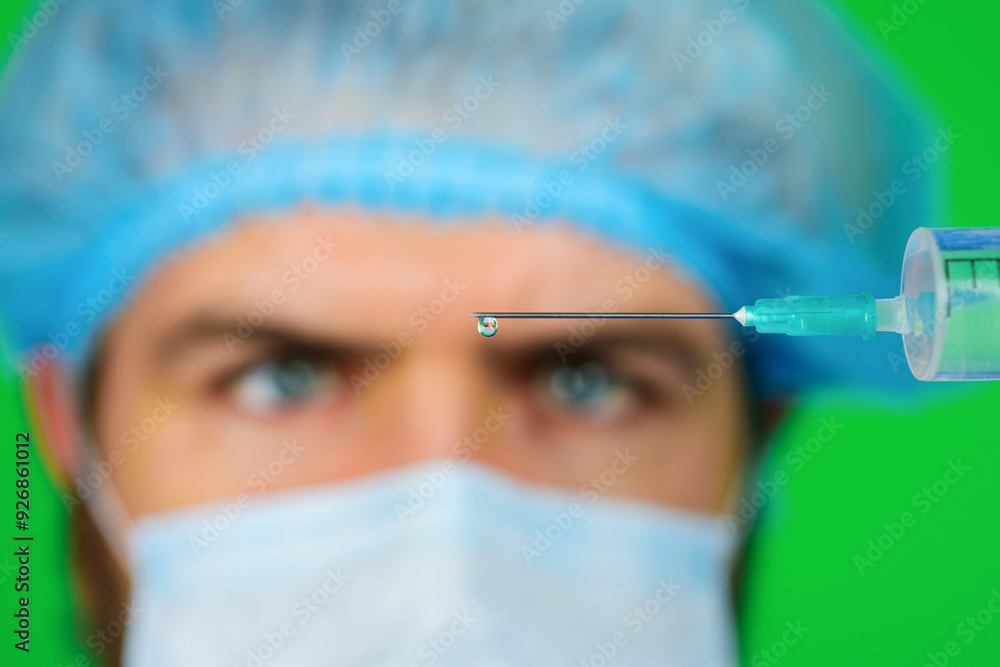 Vaccination and immunization. Physician, nurse with syringe with dose of medicine. Needle closeup. Solution for injection. Doctor in medical mask with syringe preparing for injection. Selective focus. Vaccination and immunization. Physician, nurse with syringe with dose of medicine. Needle closeup. Solution for injection. Doctor in medical mask with syringe preparing for injection. Selective focus.