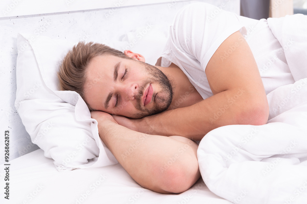 © be free - Resting peacefully in comfortable bed. Lying with closed eyes. Deep male sleep. Man sleeping at night. Sleepy man lying on bed sleeping at white bedroom. Asleep young man sleeping. Healthy regime