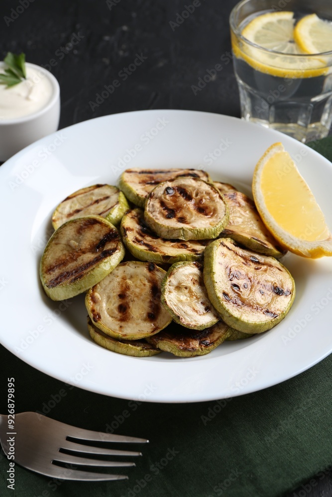 Tasty grilled zucchini slices served on black table Tasty grilled zucchini slices served on black table