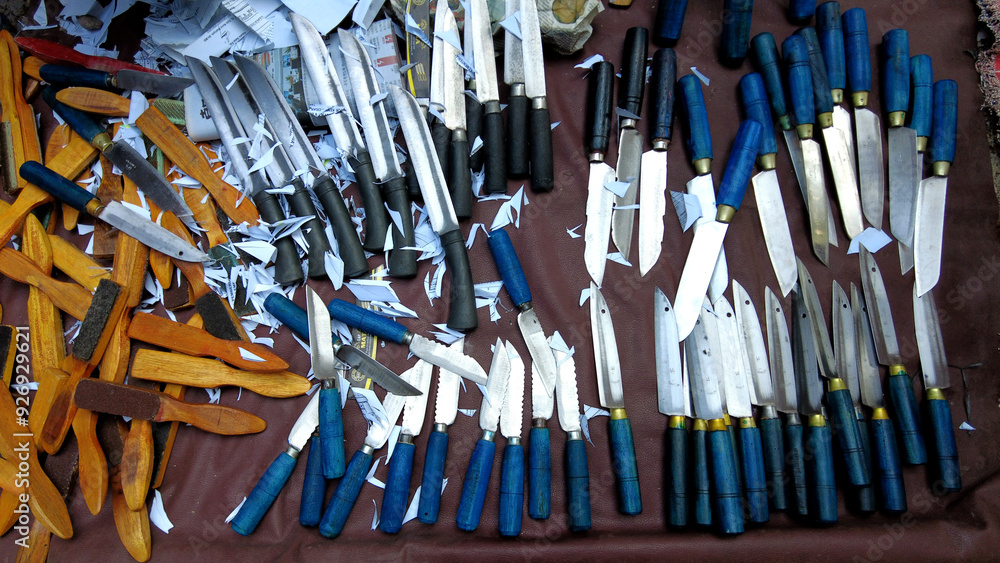 Knives for kitchen use along with sharpeners, pieces of paper for sharpness testing
Knives for kitchen use along with sharpeners, pieces of paper for sharpness testing
